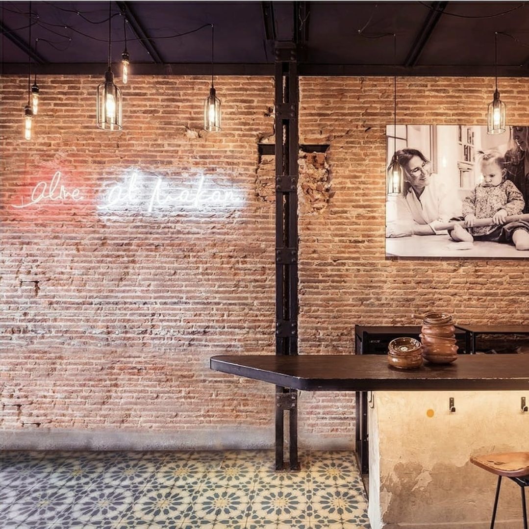 Interior de Makan con neón y ladrillo visto